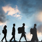 Silhouette,Of,Refugees,People,With,Luggage,Walking,In,A,Row